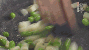 鍋中油7成熱時，入青豆、筍丁翻炒，然后加糯米飯加鹽均勻翻炒。