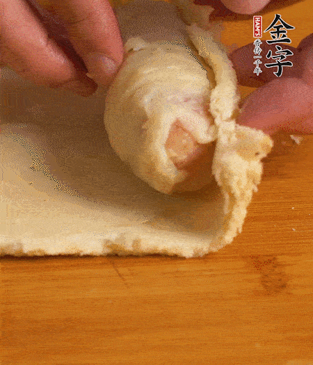 吐司卷起香腸，吐司尾端涂抹少許全蛋液，卷好的吐司表面蘸上蛋液，在裹上一層面包糠，送入預(yù)熱好的烤箱中。