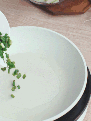 熱油下臘肉、蔥花煸炒，再下西葫蘆。