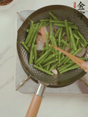 下掰好的缸豆段翻炒，略燜煮。