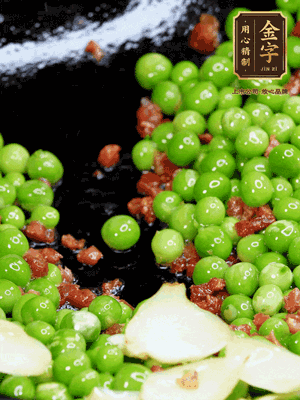 鍋內(nèi)少許油，下火腿煸香，再下甜豆米、百合翻炒，少許鹽、一點水煮到收干